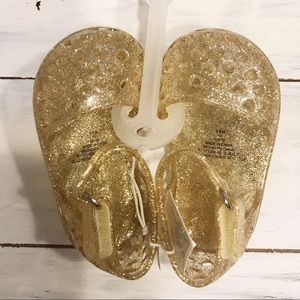 🆕 NWOT “Jelly” shoes. Gold and sparkly. Brand new!